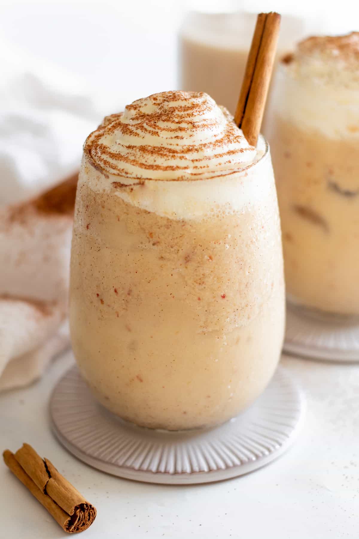 Front view of an apple pie smoothie without apple garnish but just a cinnamon stick