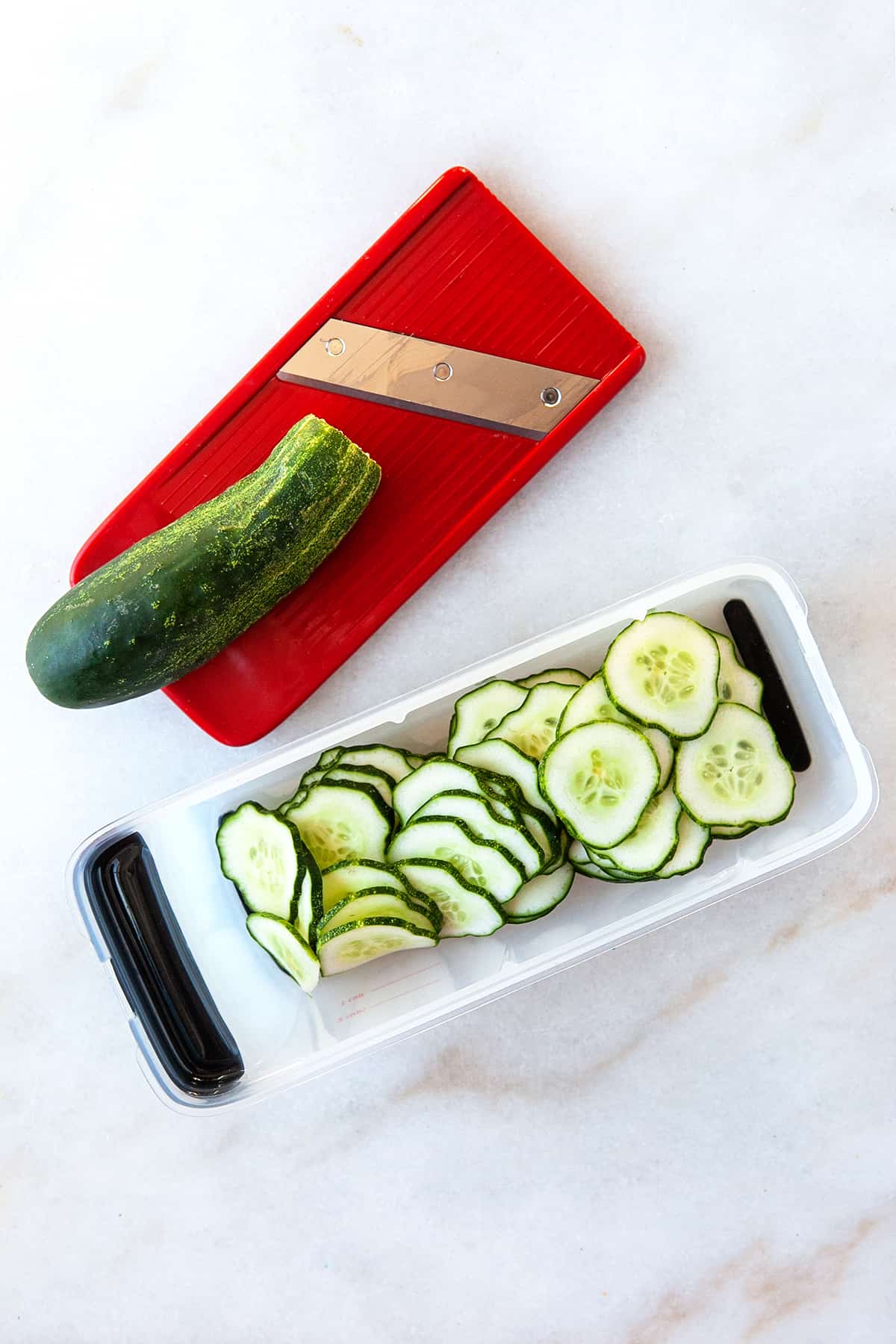 Cucumbers sliced to make Bread and Butter Pickles