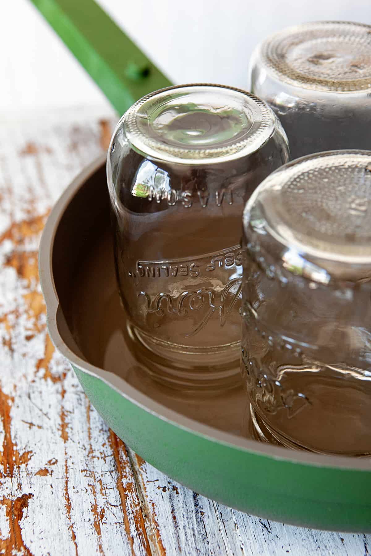 Jars upside down in a pan of hot water