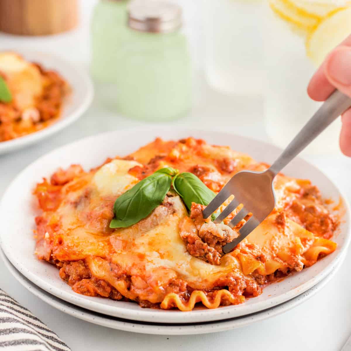 Sticking a fork into a plate of skillet lasagna