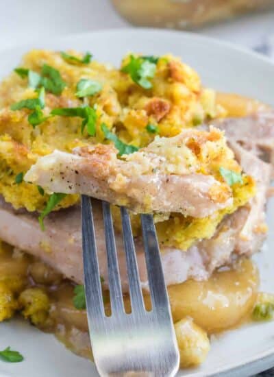 4 Ingredient Oven Baked Pork Chops on a plate with a forkful.