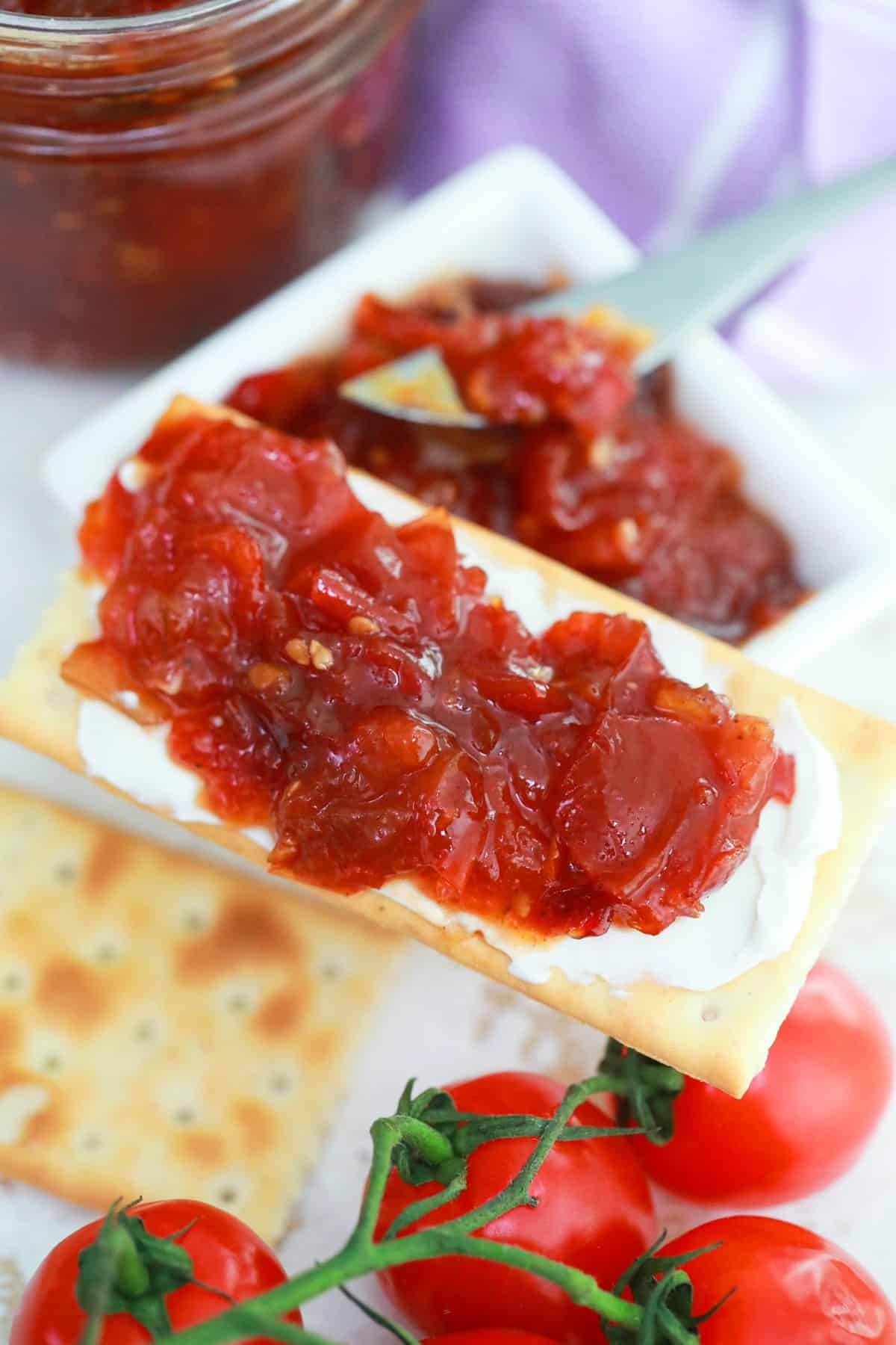 Tomato jam on a cracker with cream cheese.