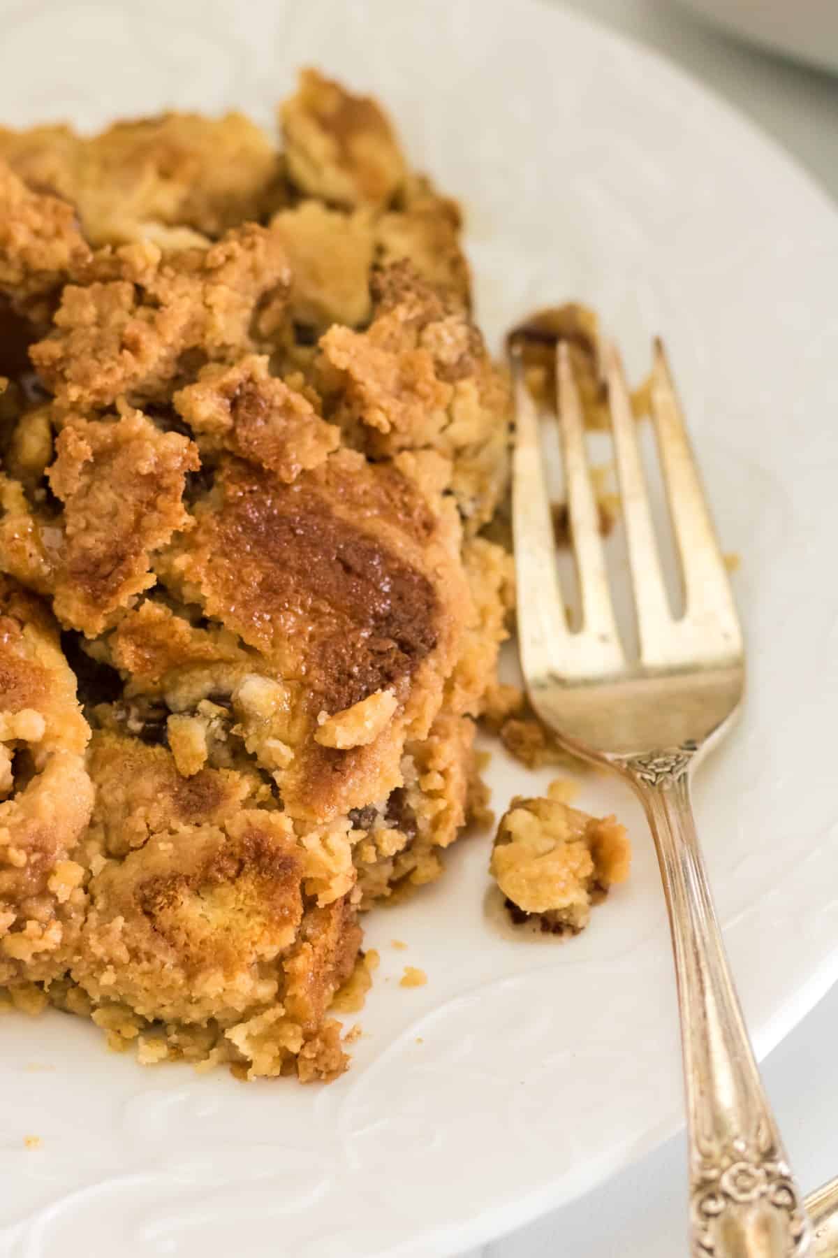 Apple dump cake on a plate with a fork. 