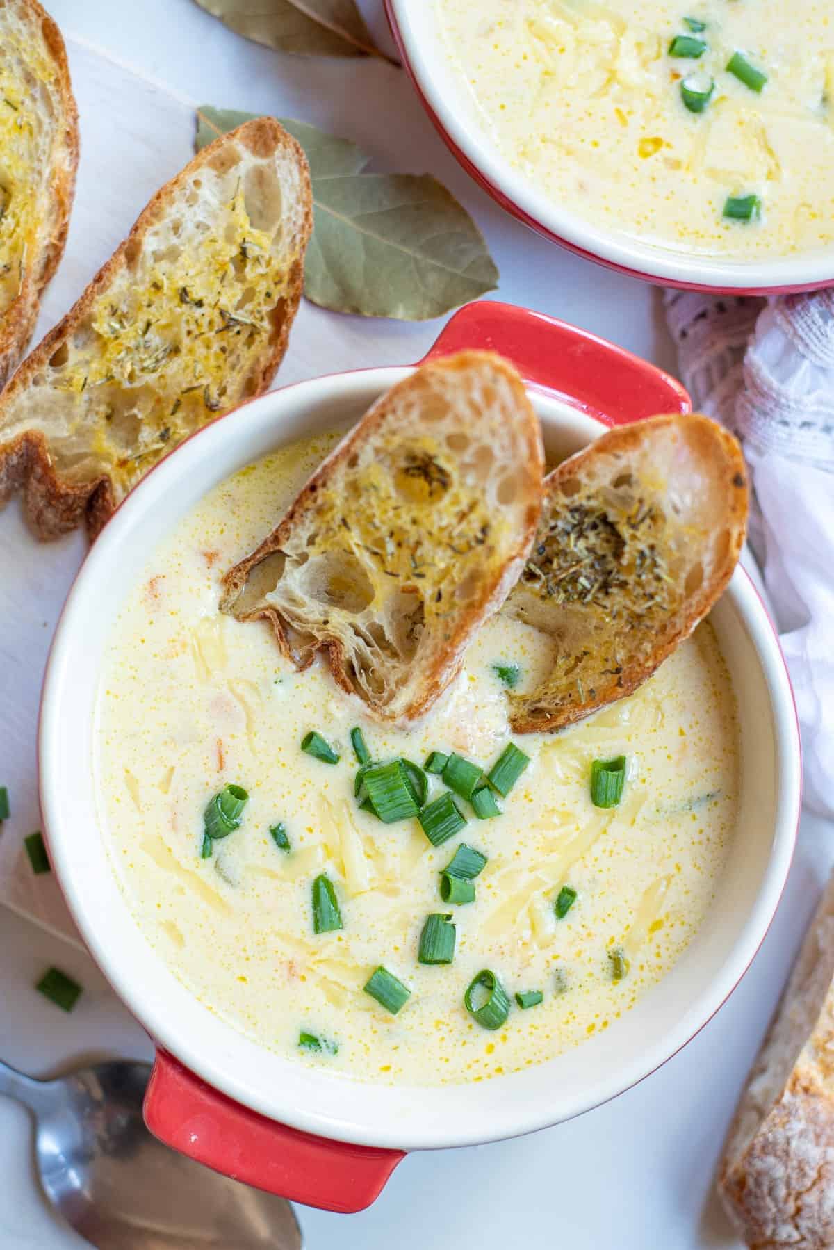 Overhead bowl of beer cheese soup with garlic toasts. 
