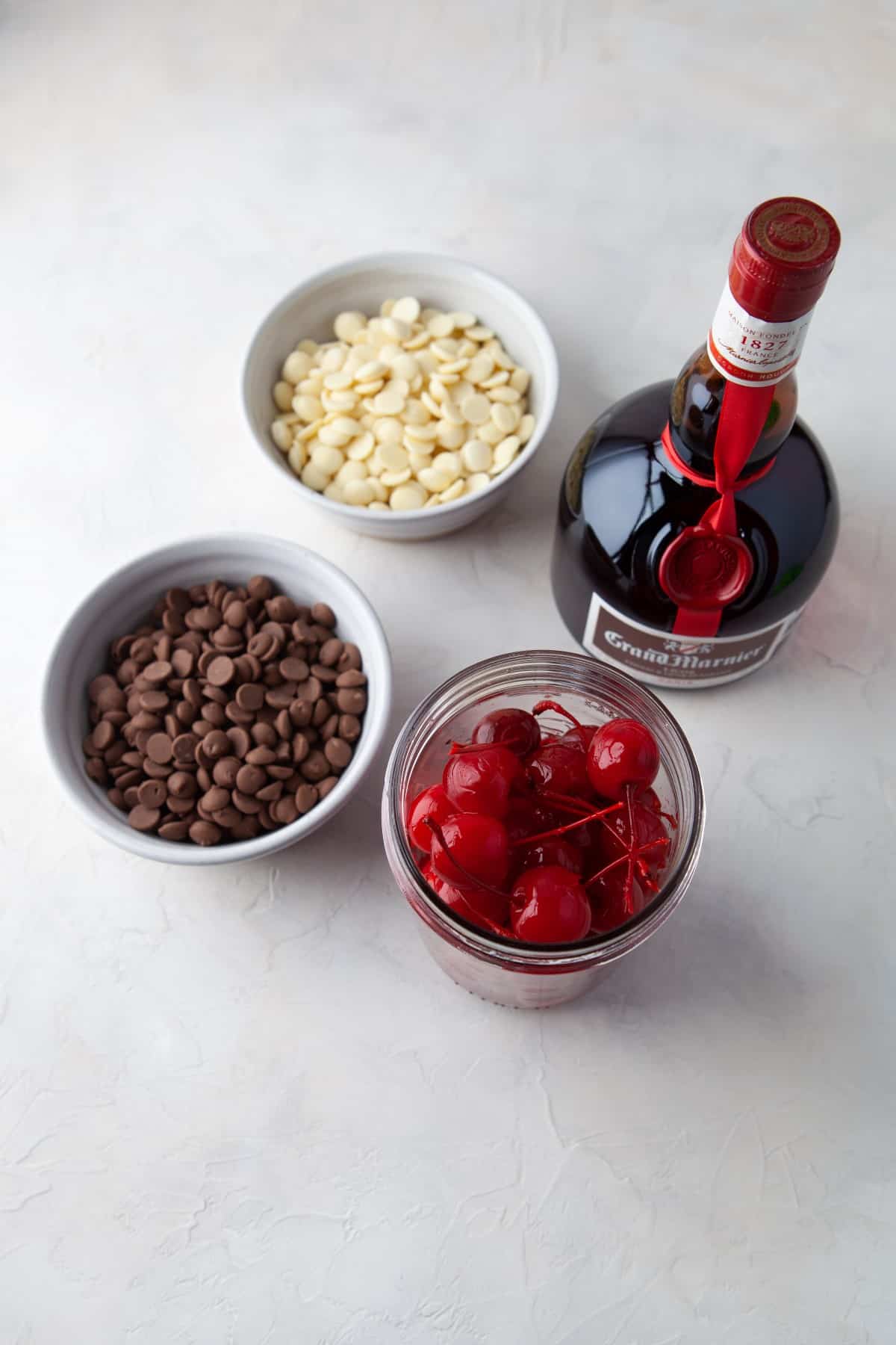 Ingredients for Grand Marnier Chocolate Cherries on a white countertop.