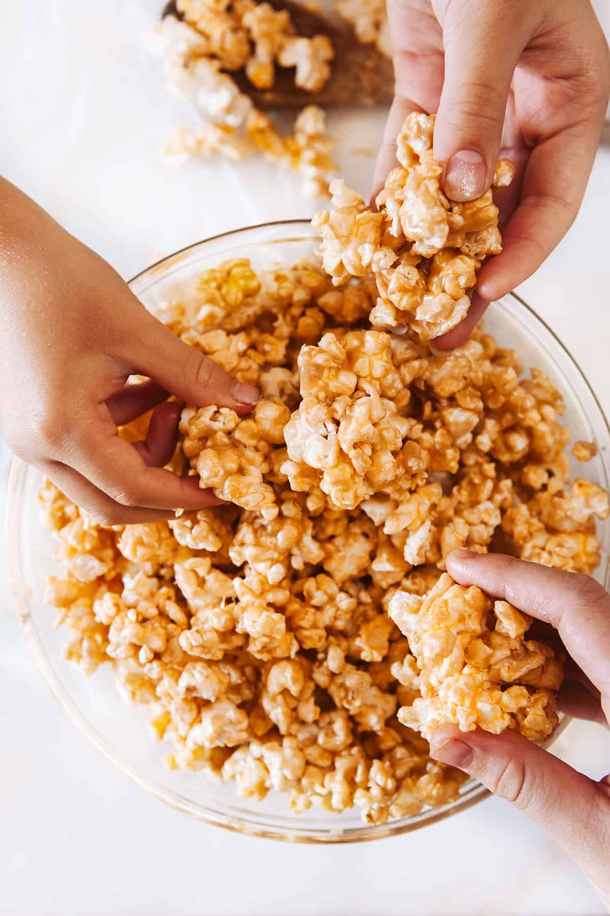 Grabbing peanut butter popcorn from  a bowl