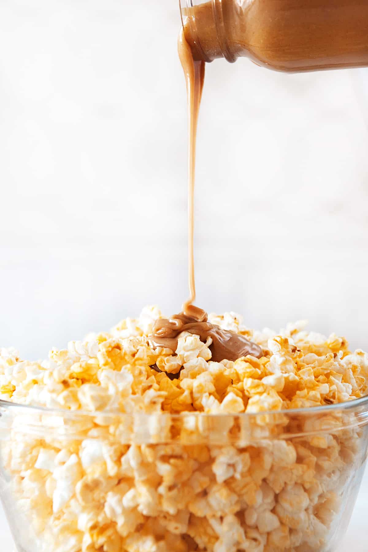 Pouring the sauce onto Peanut BUtter Popcorn.