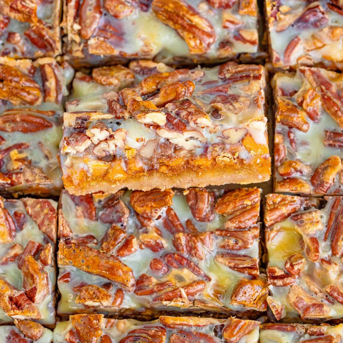 Overhead close-up of Pecan Magic Pumpkin Bars with the middle one tilted out. 