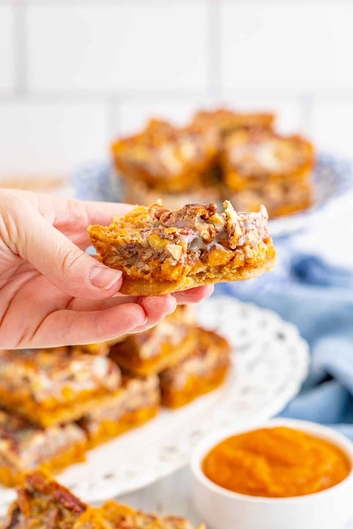 Holding a pumpkin bar with a bite taken. 