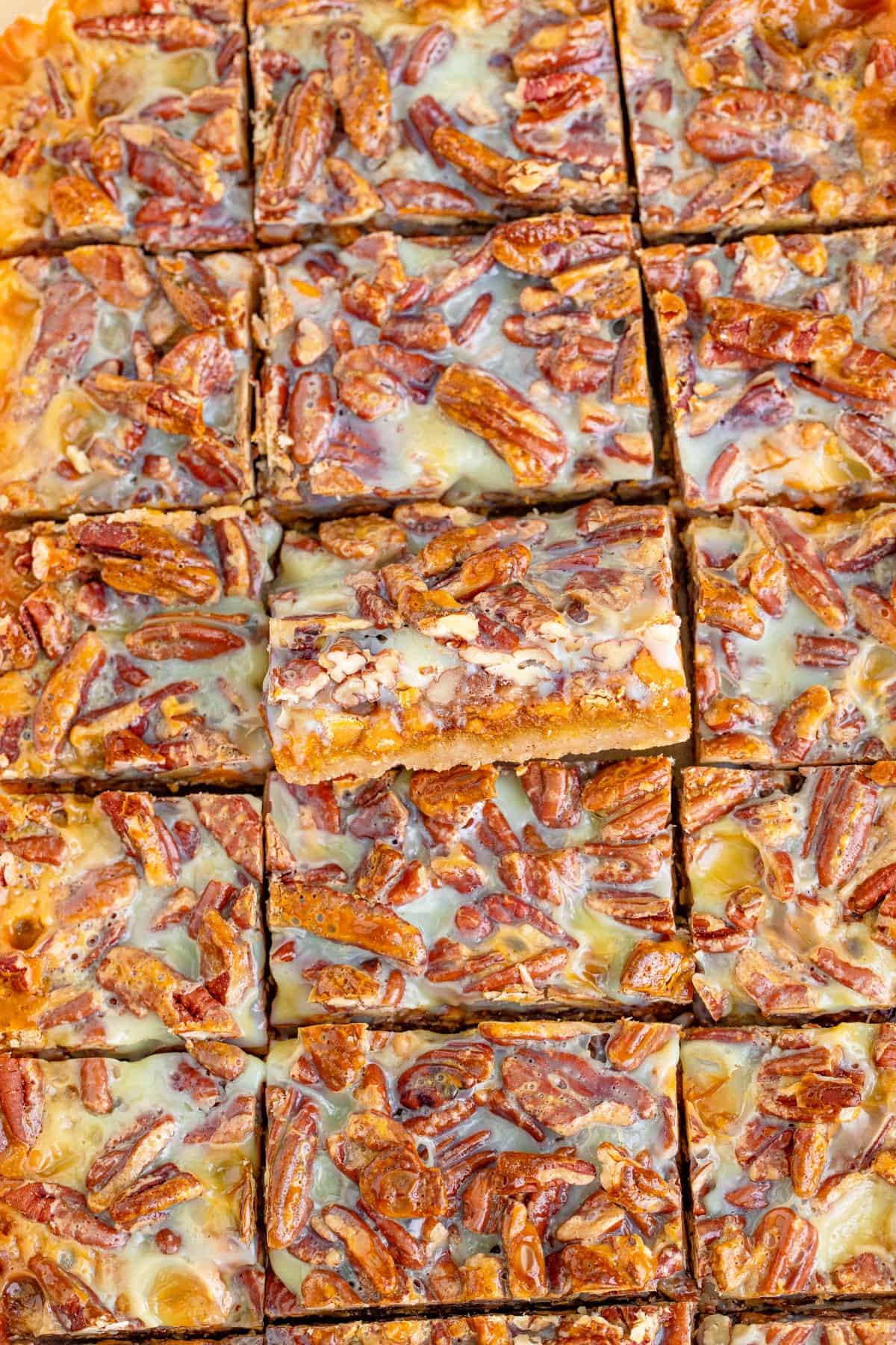 Pumpkin bars cut into squares with the middle one tilted outward.