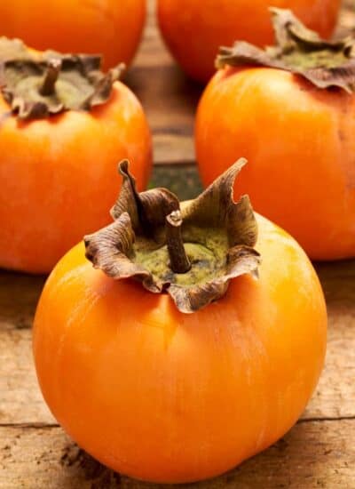 Persimmons on a board.