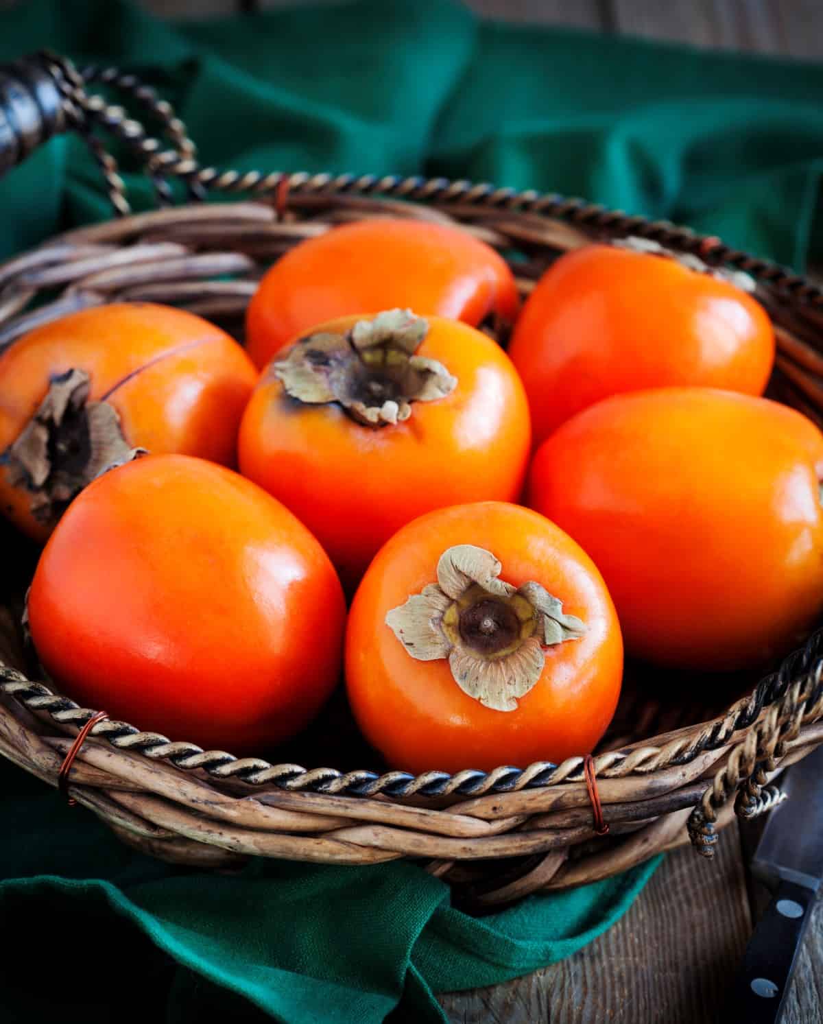 Persimmons in a woven bowl. 