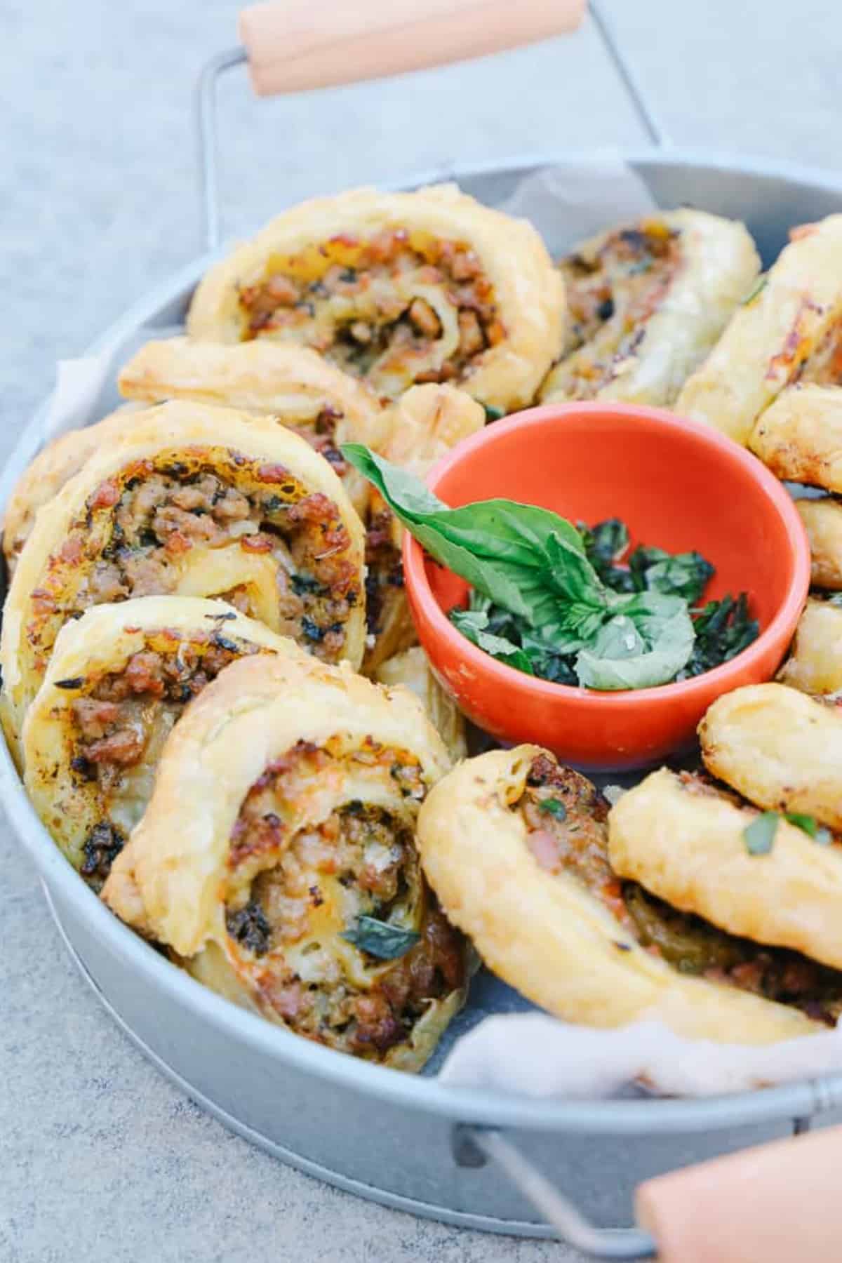 Delicious sausage pinwheels in a tin round container
