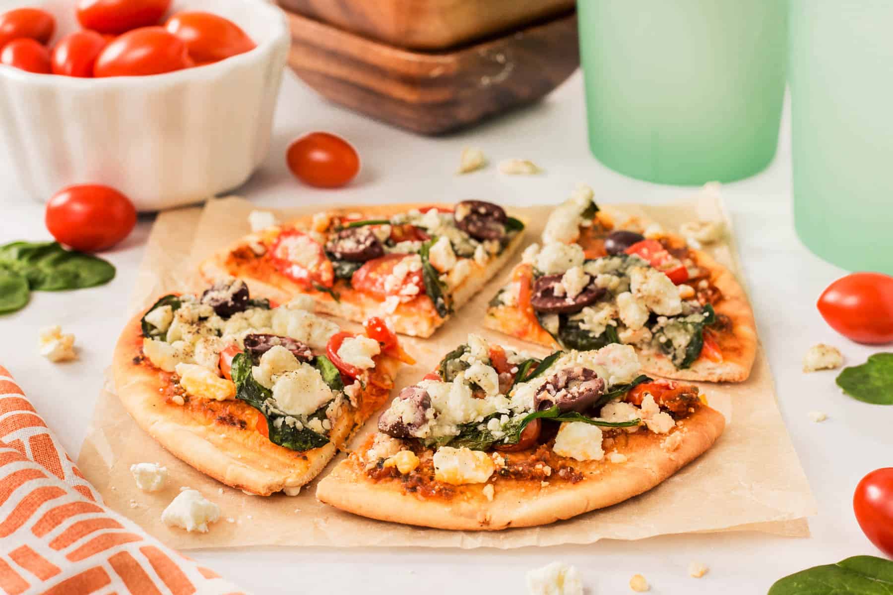 Horizontal picture of Greek pita pizza on parchment