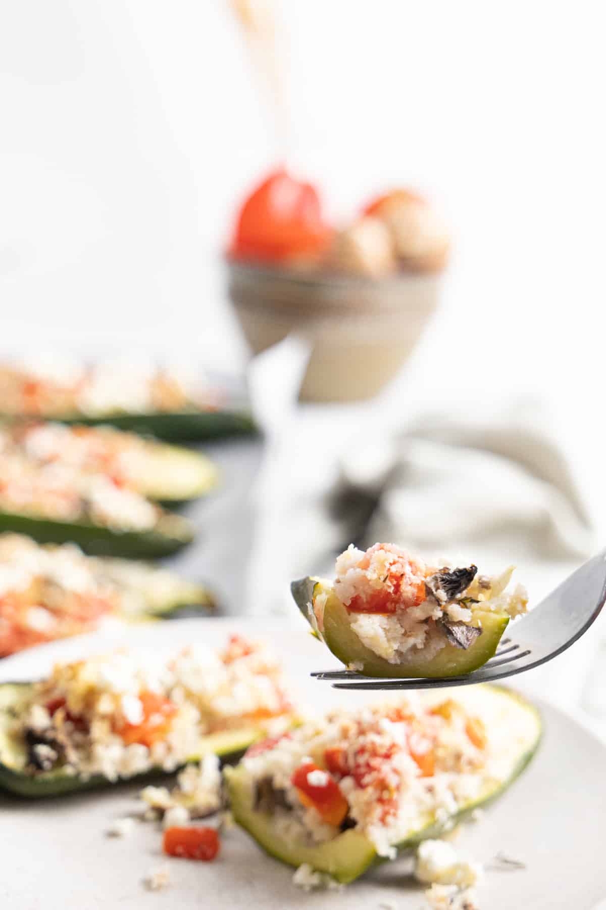 Close up of a piece of stuffed zucchini on a fork.