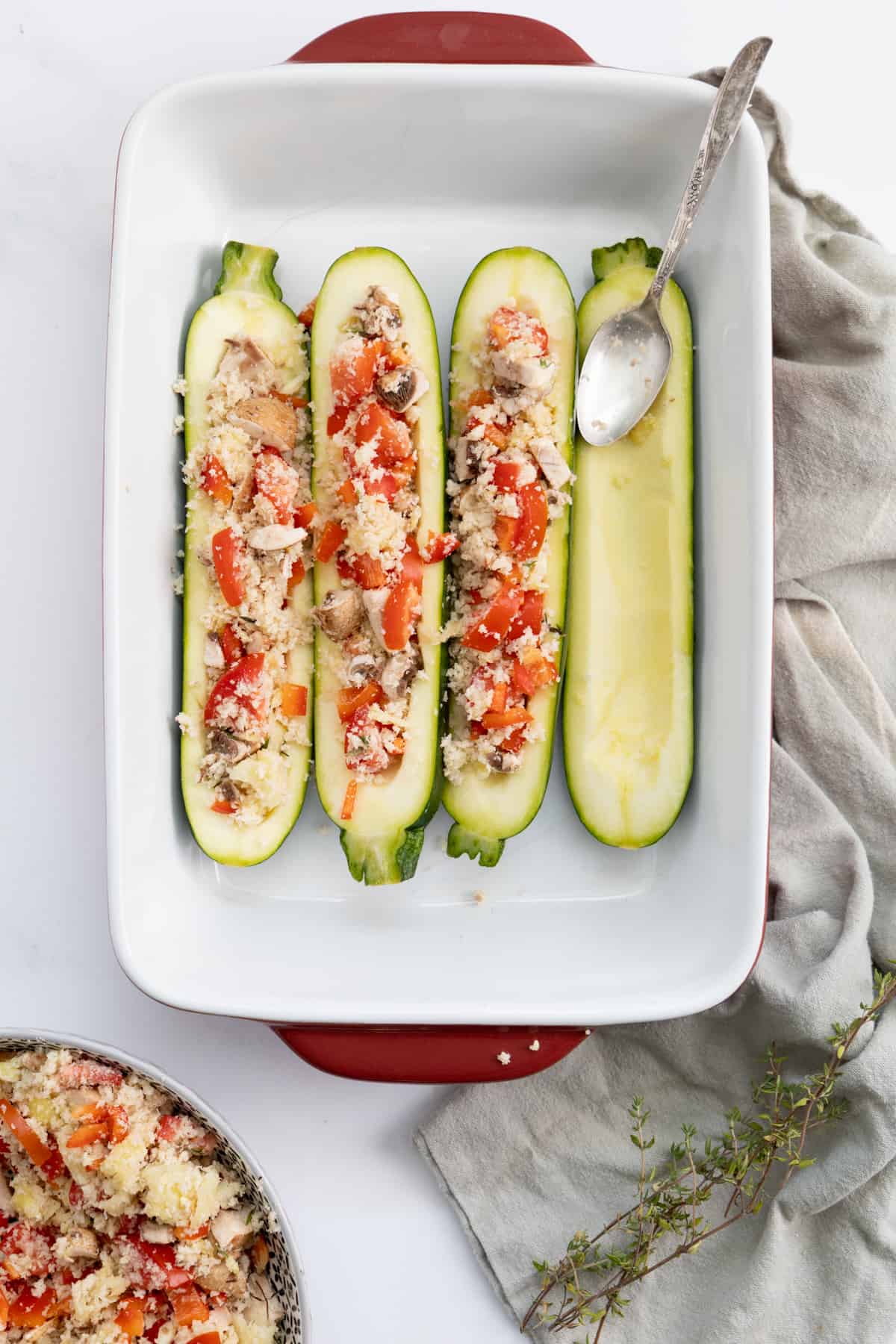 Top view of uncooked zucchinis stuffed with vegetarian filling