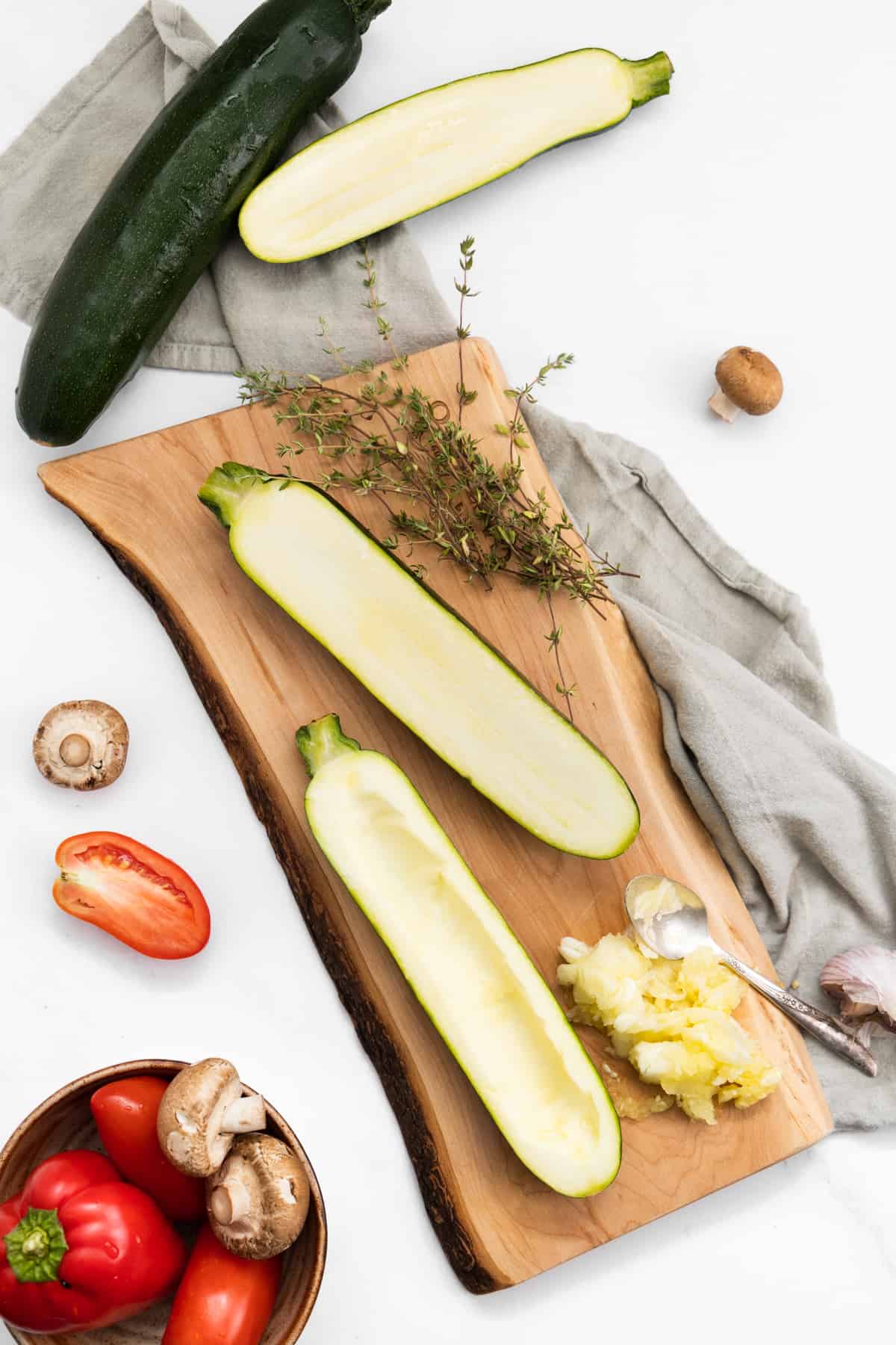 Top view of zucchini halves on a wood board