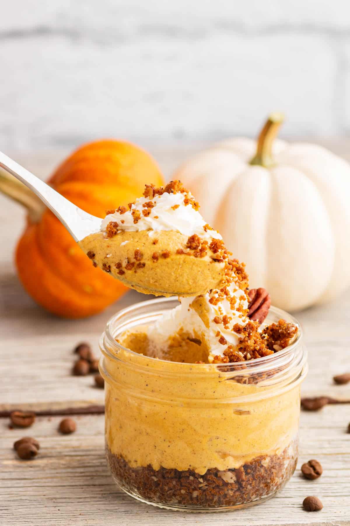 A spoon holds a biteful of creamy Pumpkin Delight dessert.