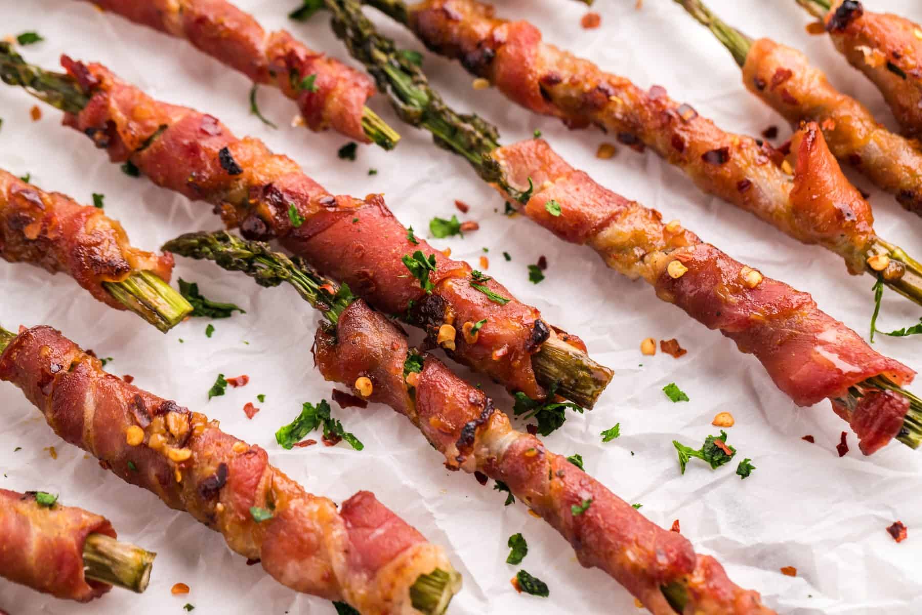 Bacon Wrapped Asparagus on parchment paper.