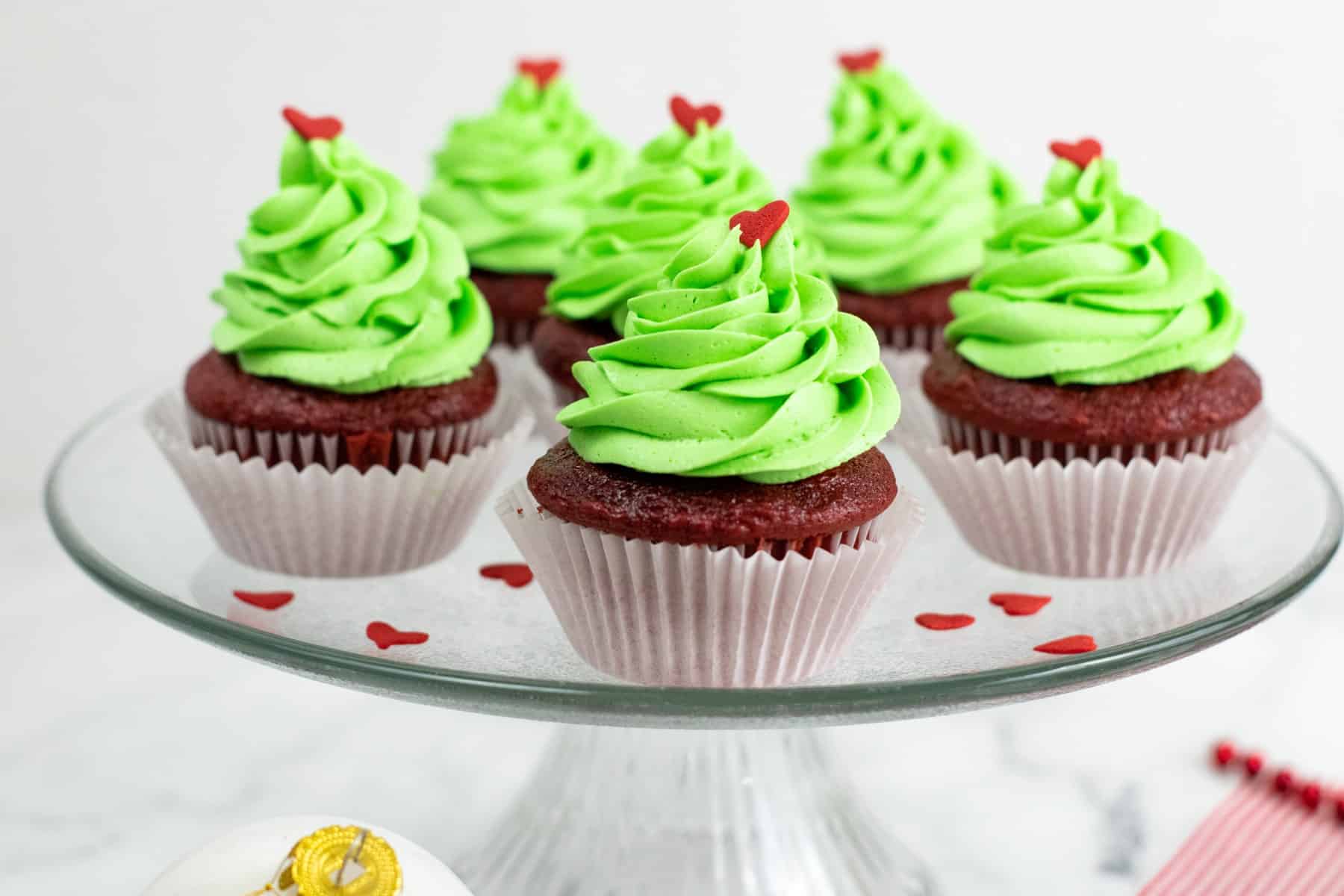 Grinch cupcakes on a cake platter. 