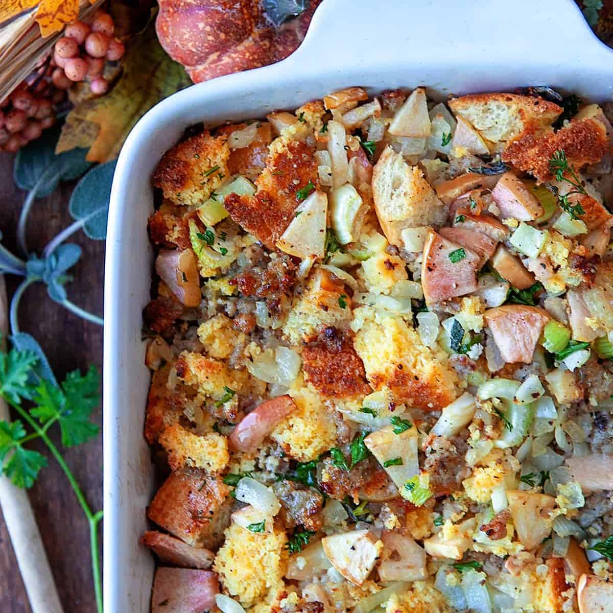 Square photo overhead of cornbread dressing in a casserole dish. 