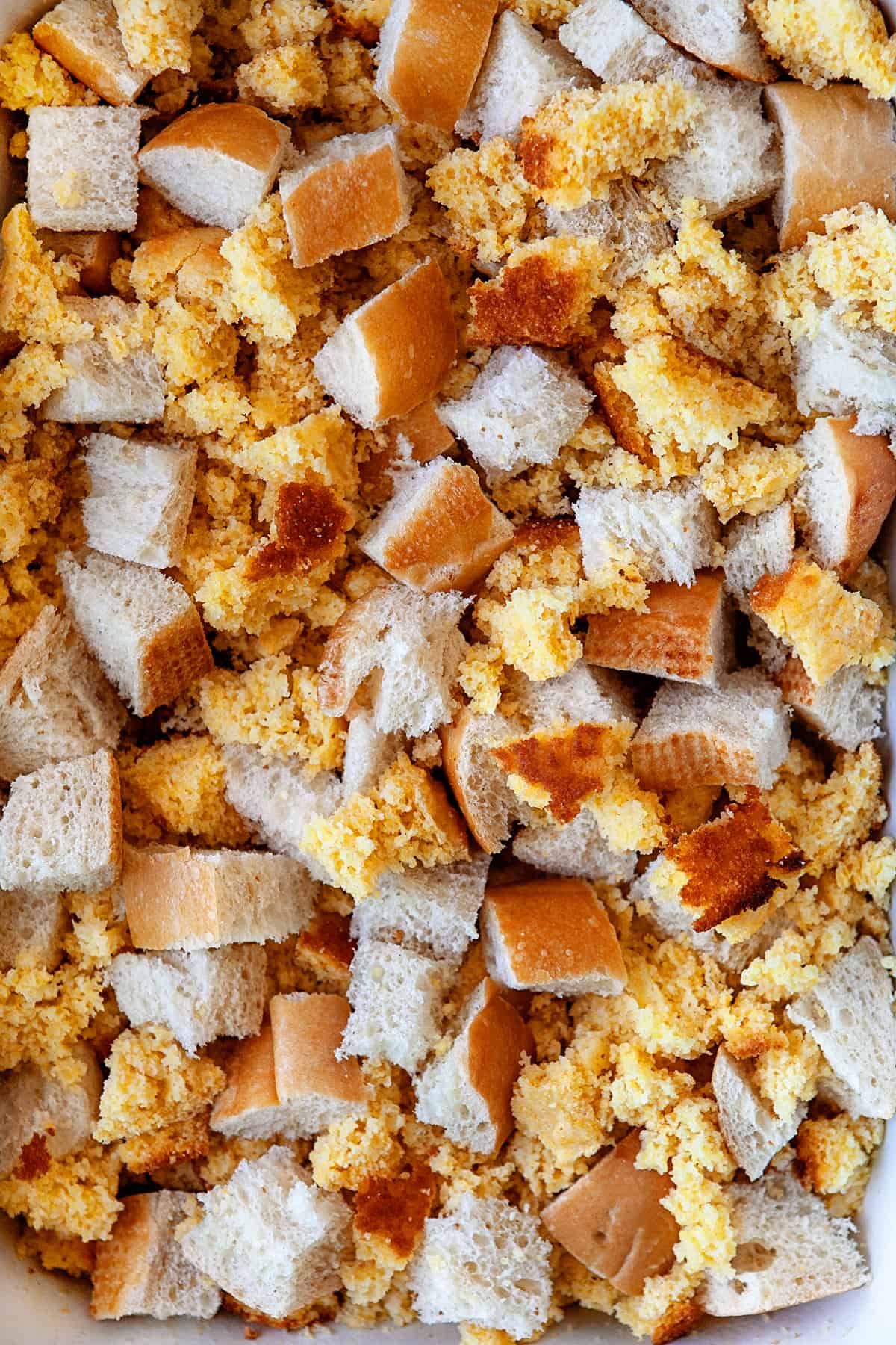 Cornbread and white bread torn into pieces. 