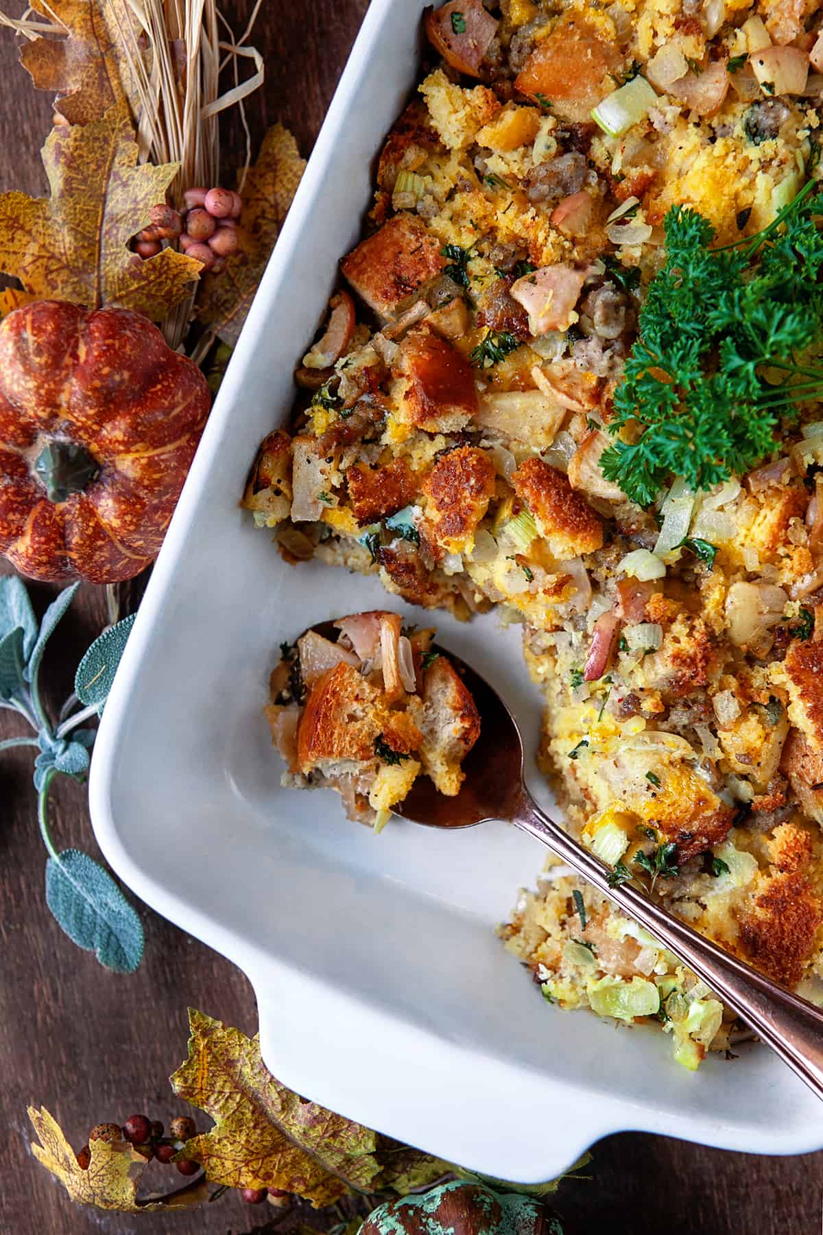 Spooning out Old-Fashioned Cornbread Dressing from a casserole dish