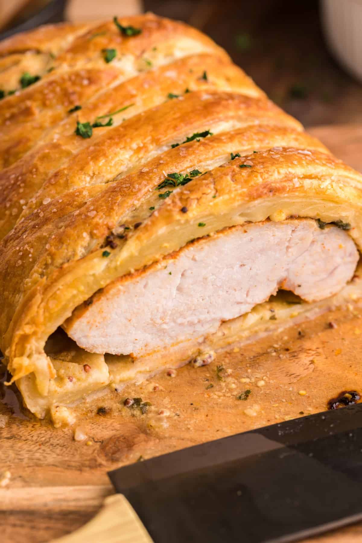 Showing the inside of a pork tenderloin in puff pastry. 