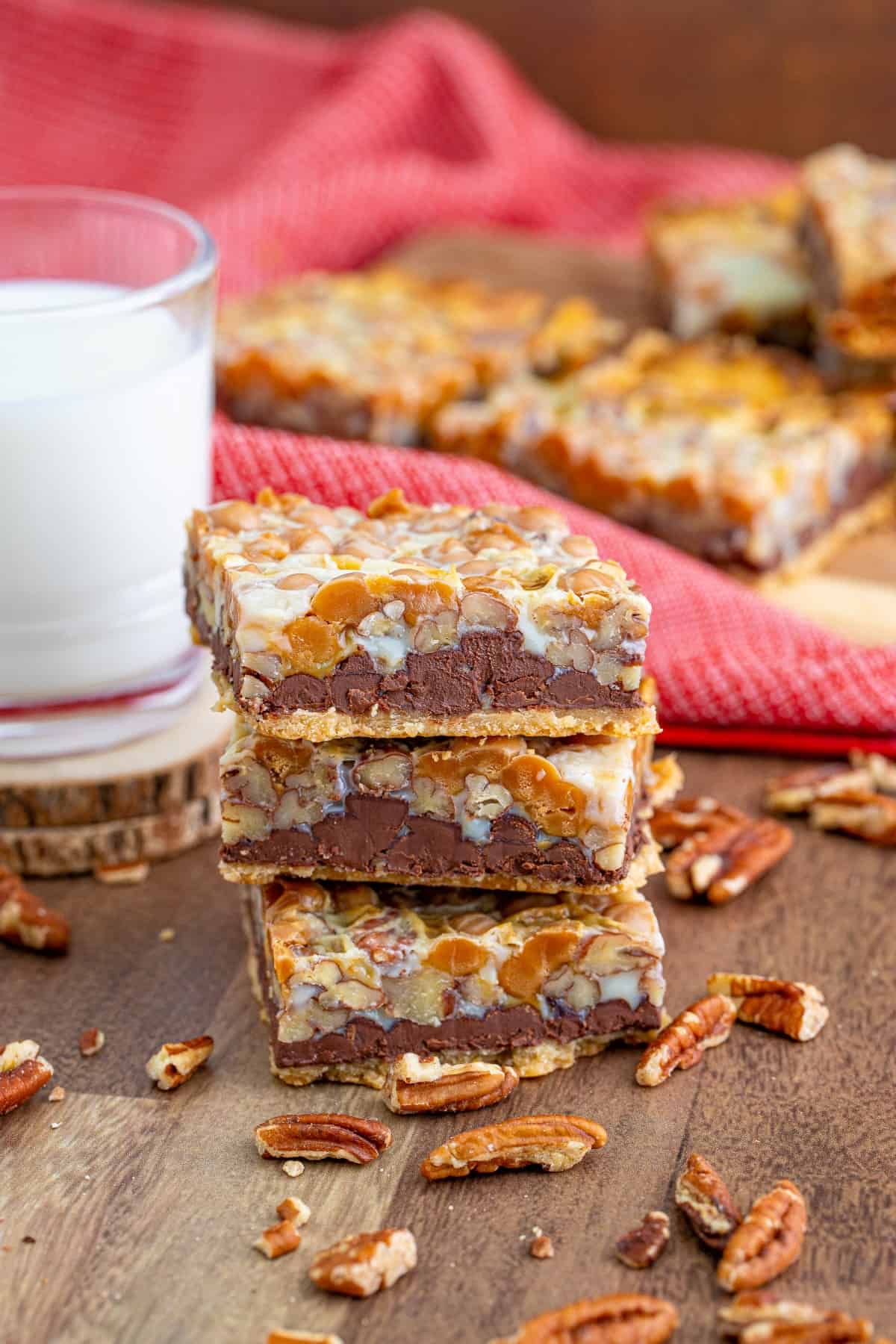 Stacked Scrumptious Turtle Bars with a glass of milk 