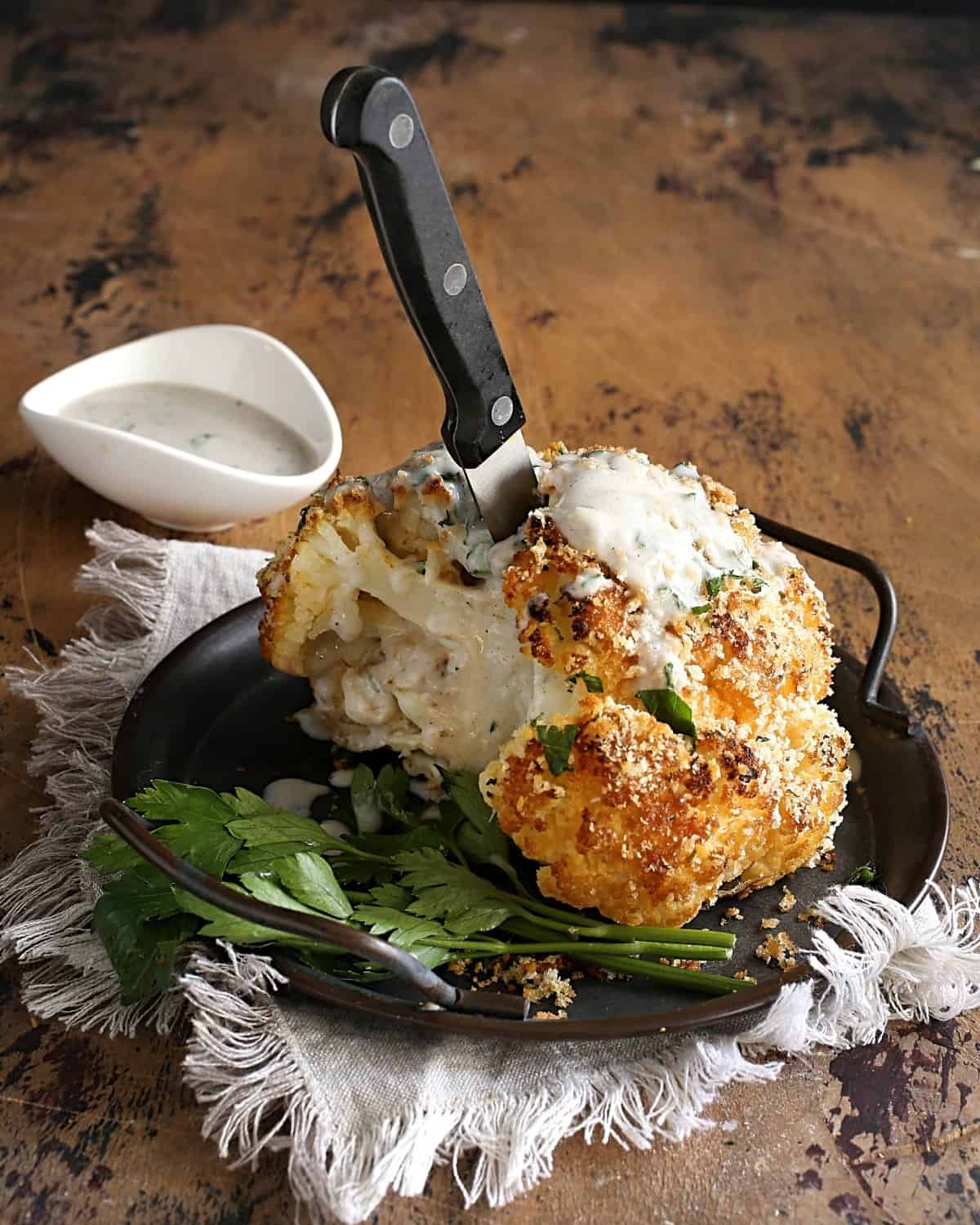 Roasted cauliflower with a knife stuck in it. 