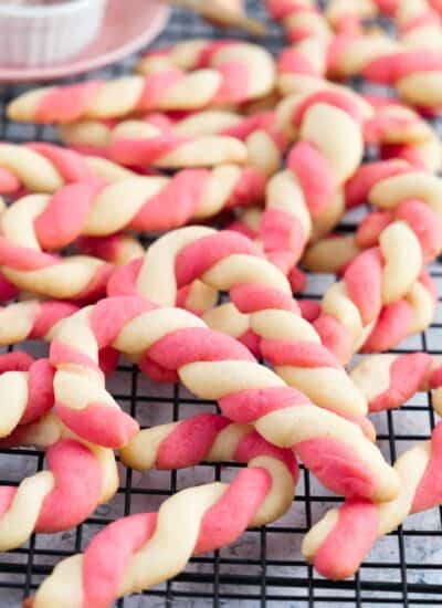 close up of a lot of candy canes on a cooling rack