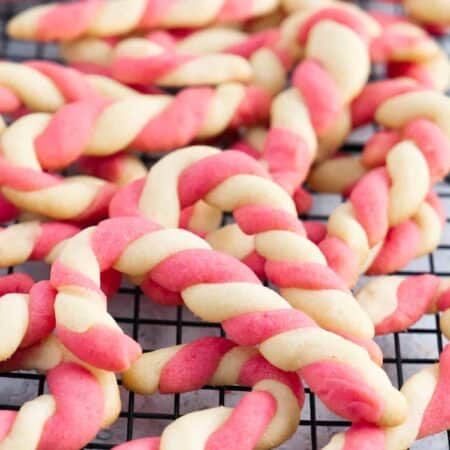 close up of a lot of candy canes on a cooling rack