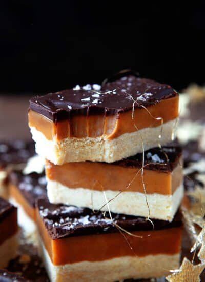 Stacked Millionaire Shortbread, top square has a bite taken