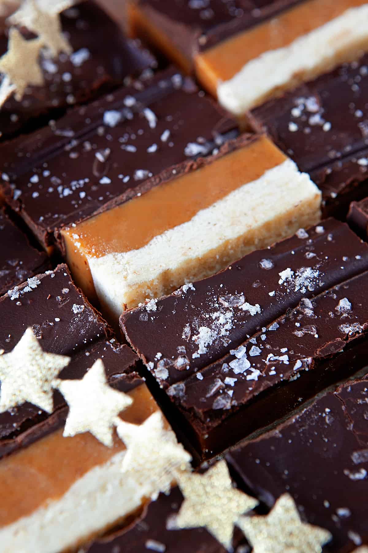 Millionaire shortbread tucked close together with some on their side. 