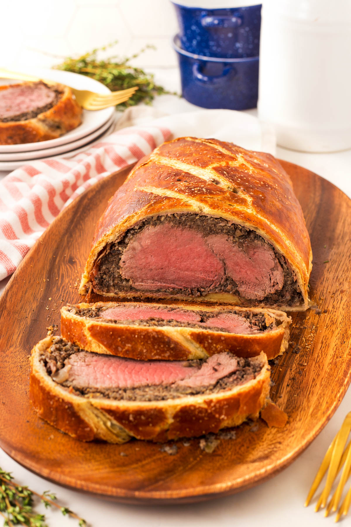 Perfect Beef Wellington sliced on a wooden board. 