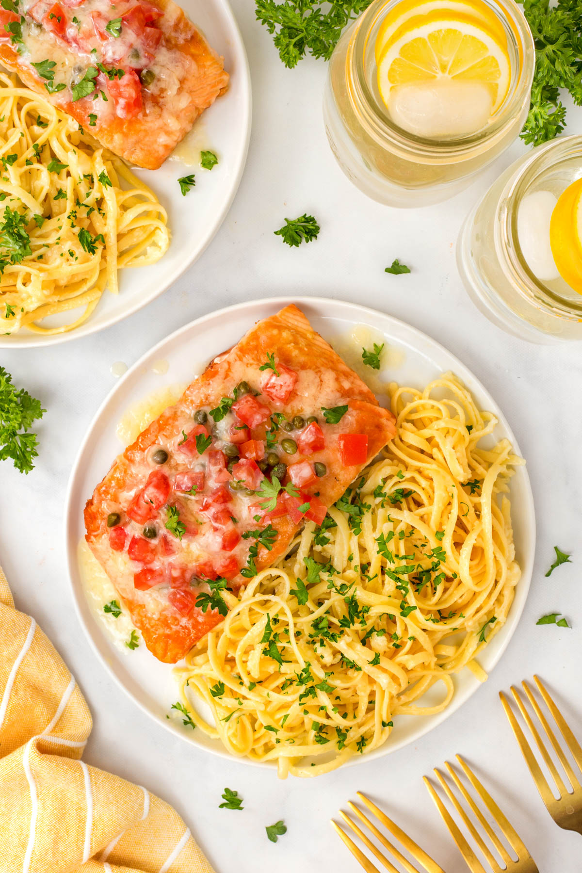 Overhead of Salmon Sorrento and Linguine Alfredo on a plate. 