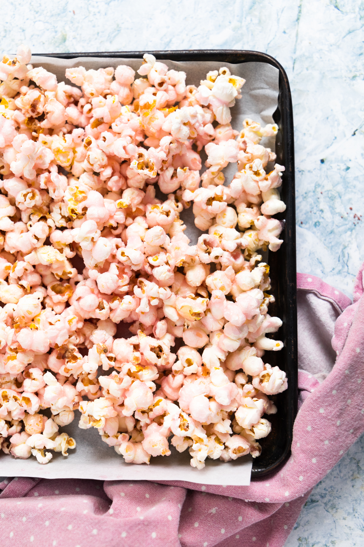 top view of pink popcorn on a baking tray