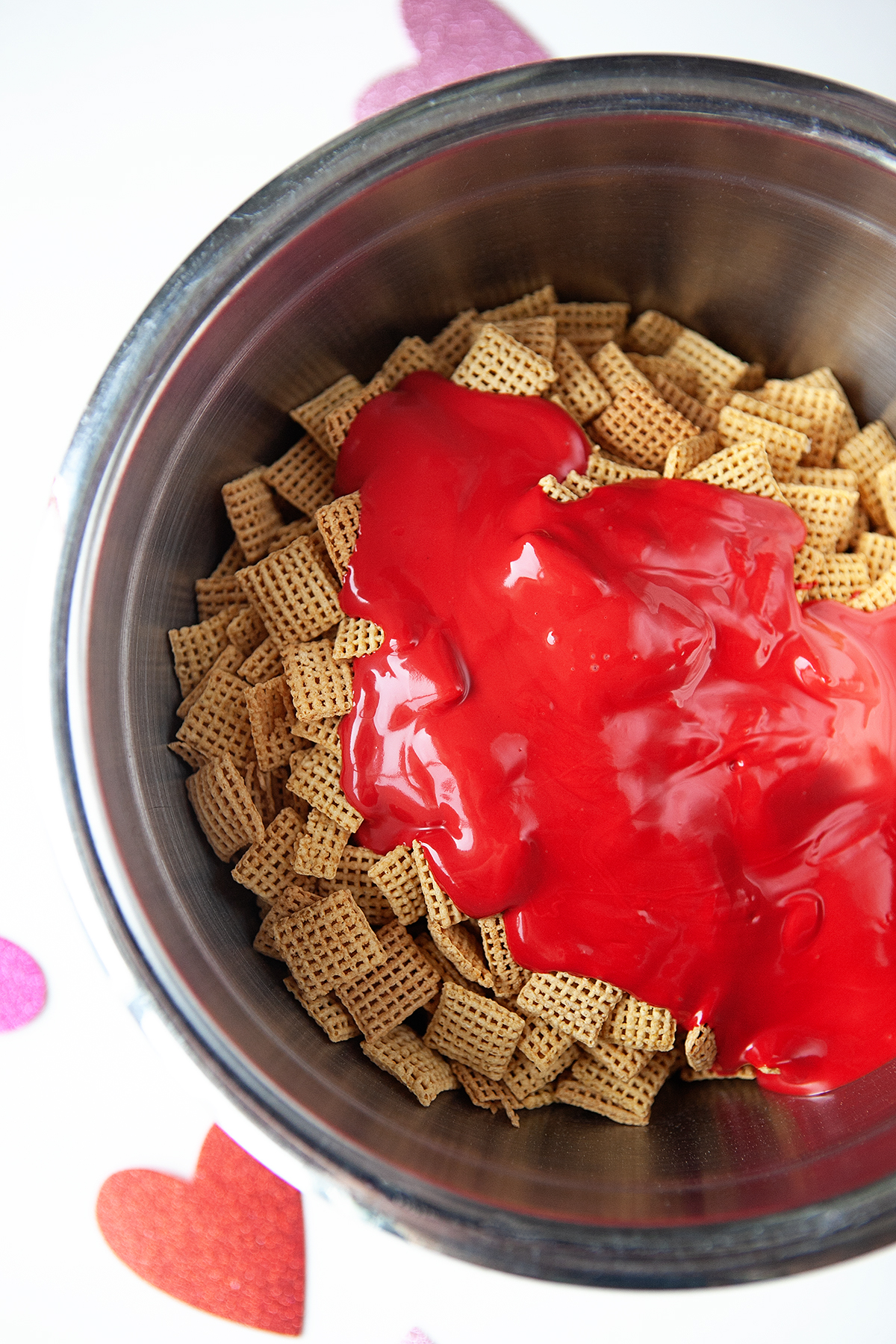Red candy melts poured over Chex cereal. 