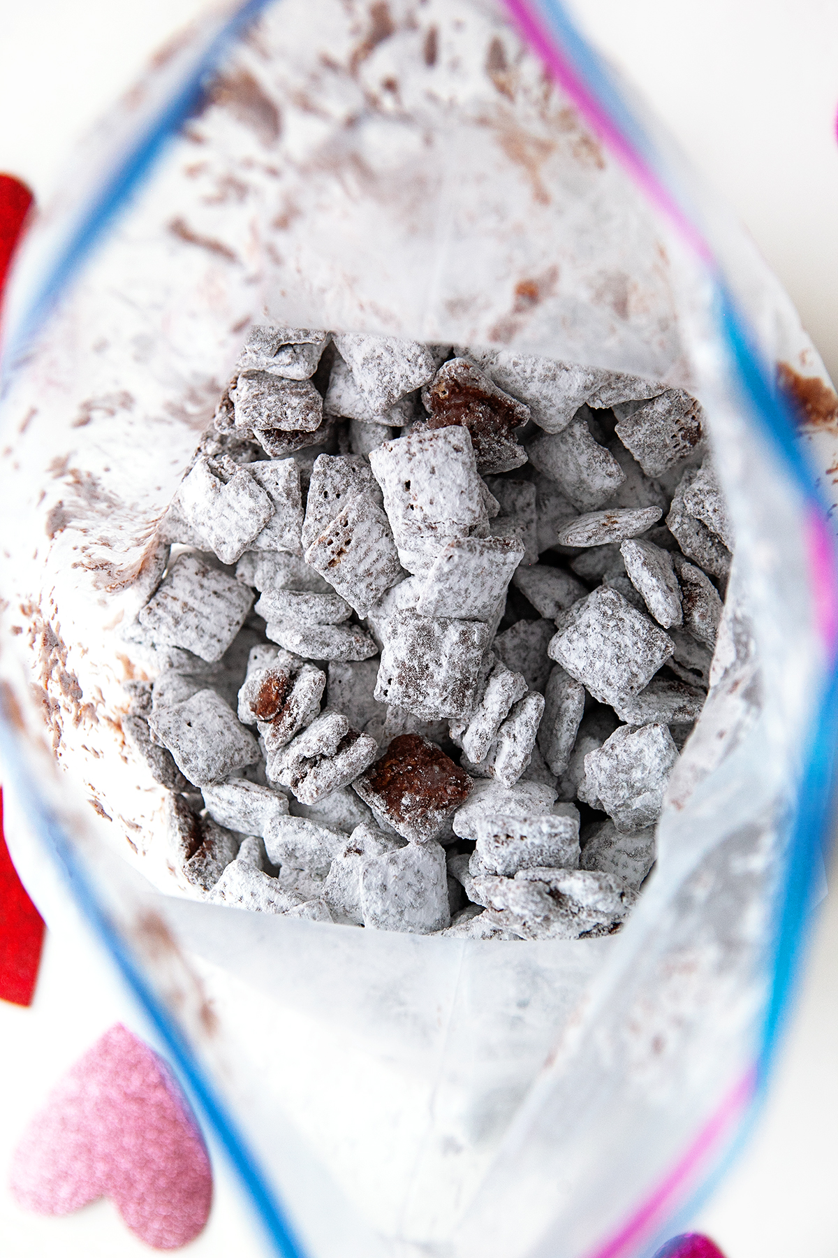Chocolate covered Chex cereal shaken in a bag with powdered sugar. 