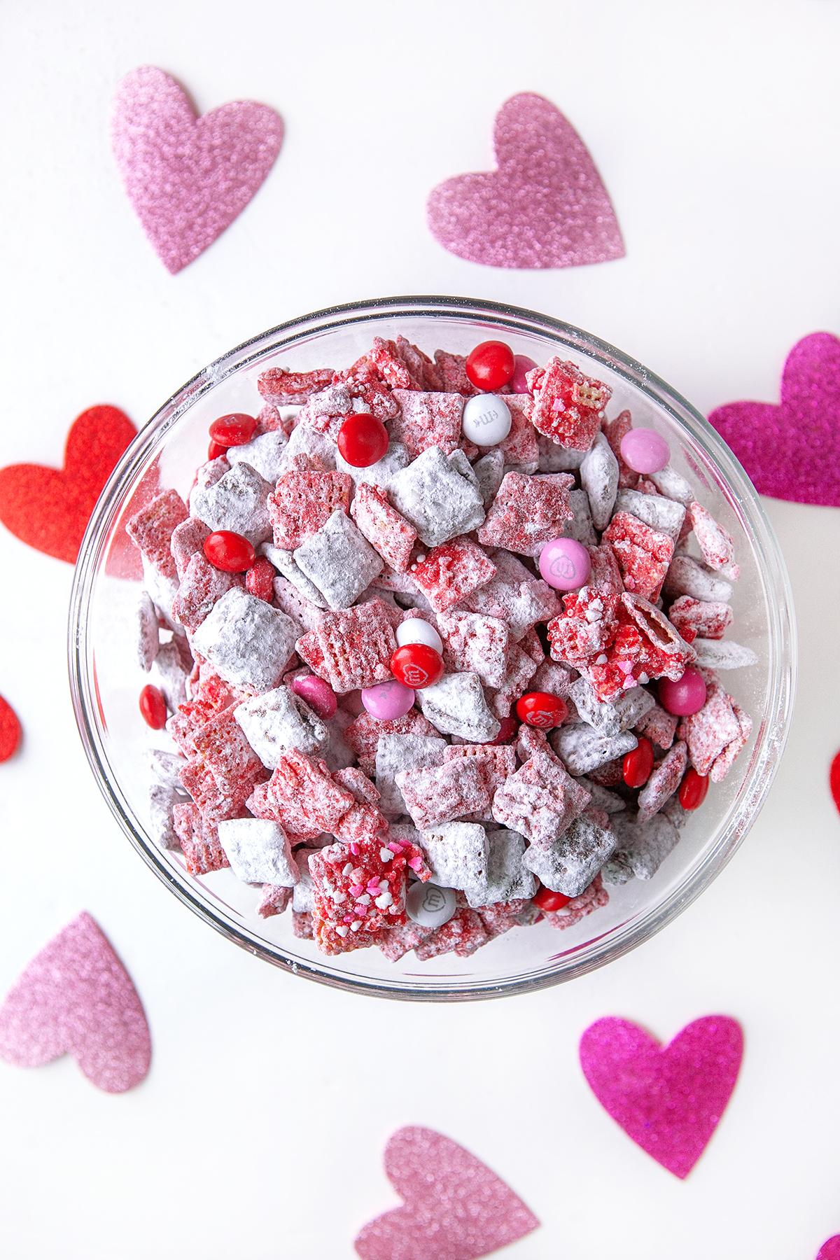 Valentine's Day Puppy Chow, overhead shot in a glass bowl. 
