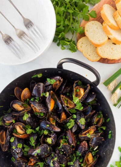 Overhead shot of Thai Curry Mussels in a pan.