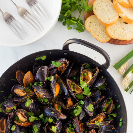Overhead shot of Thai Curry Mussels in a pan.
