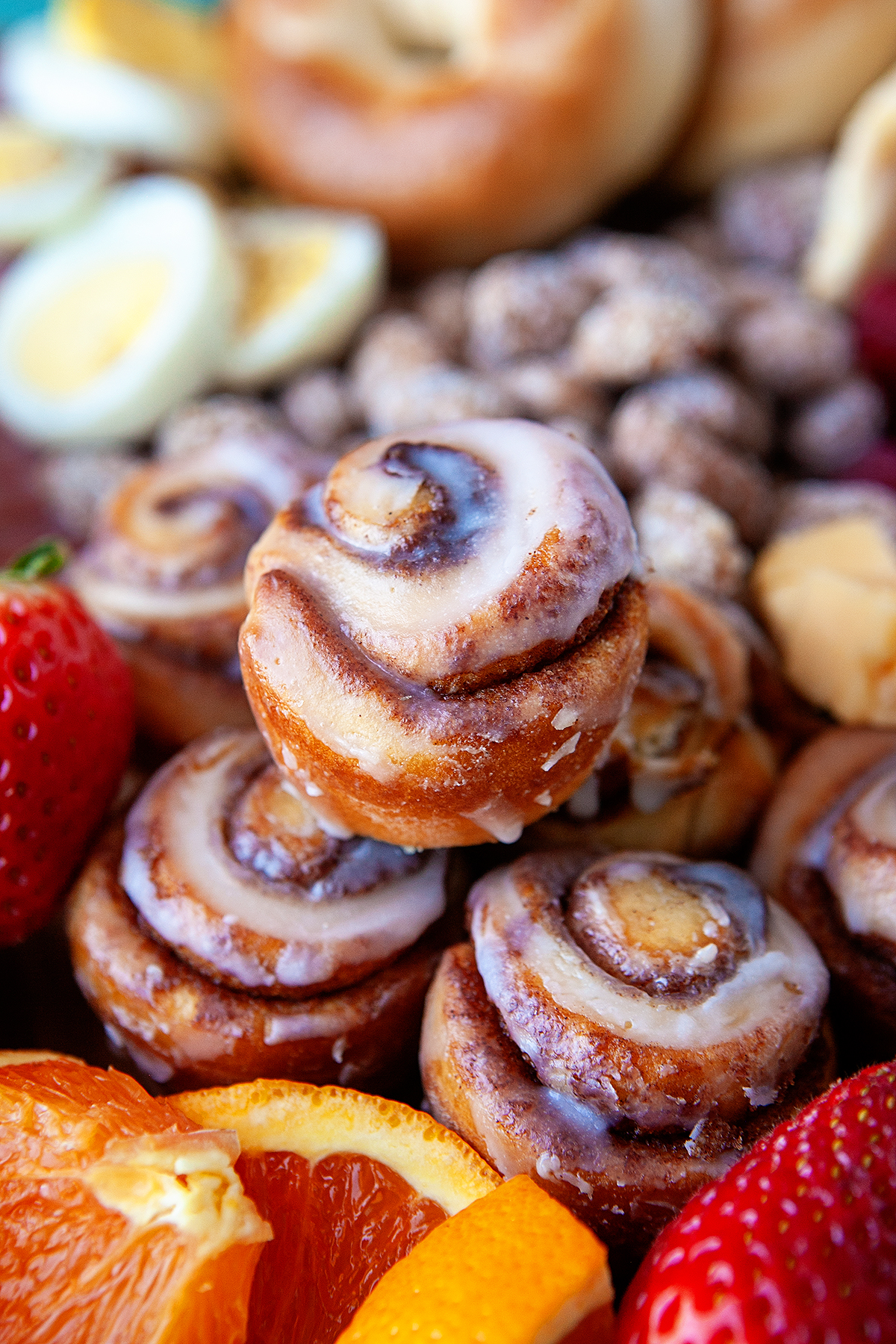 Close-up of cinnamon knots surrounded by fruit and nuts