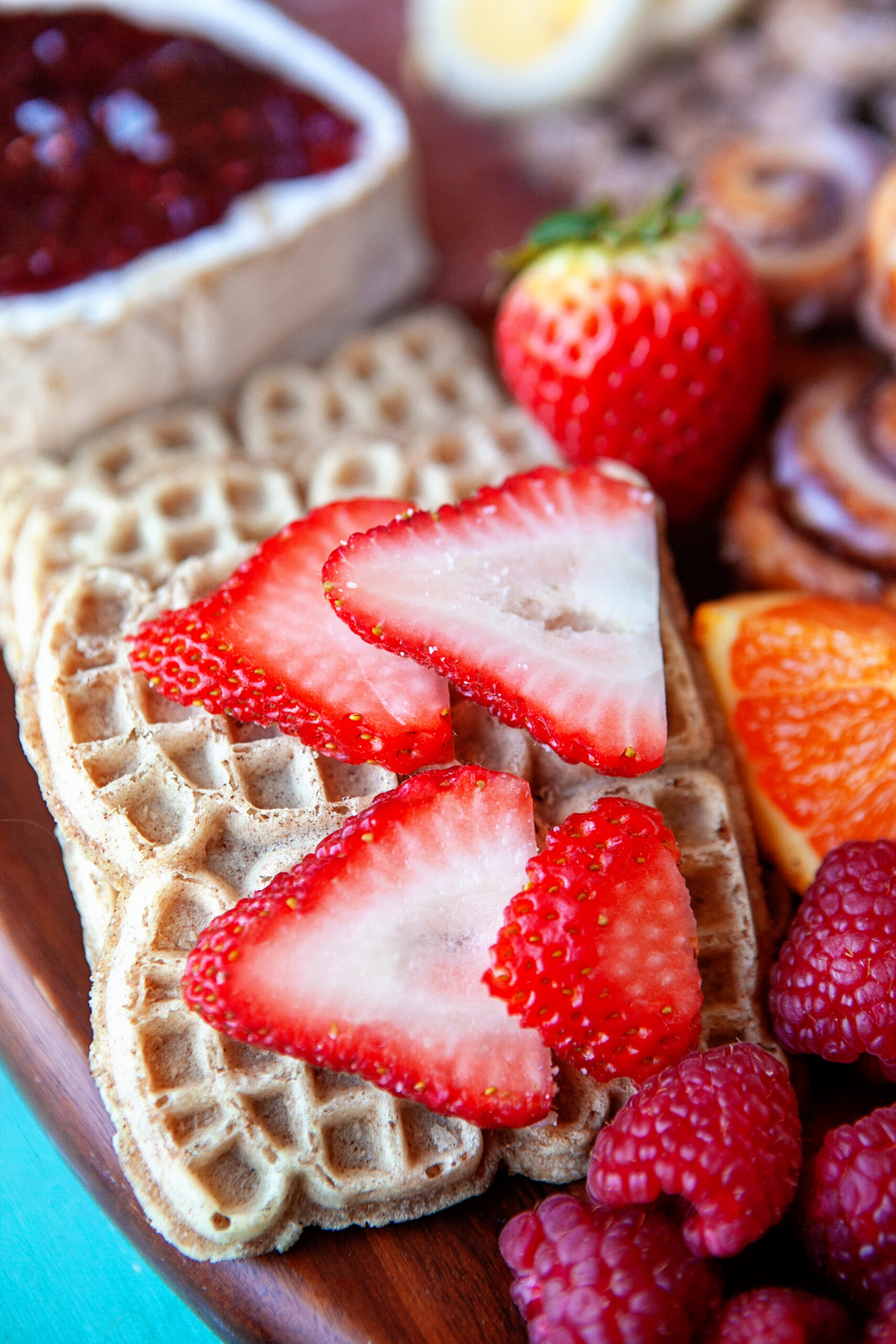 Sliced strawberries on mini waffles. 