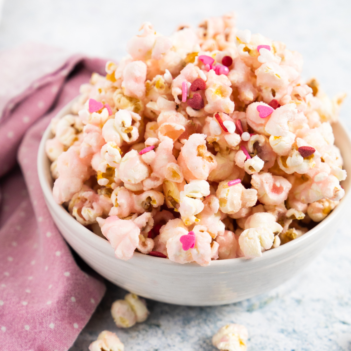 side view of pink popcorn in white bowl