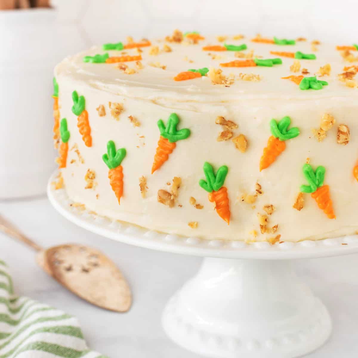 Square photo or a carrot cake on a cake stand. 