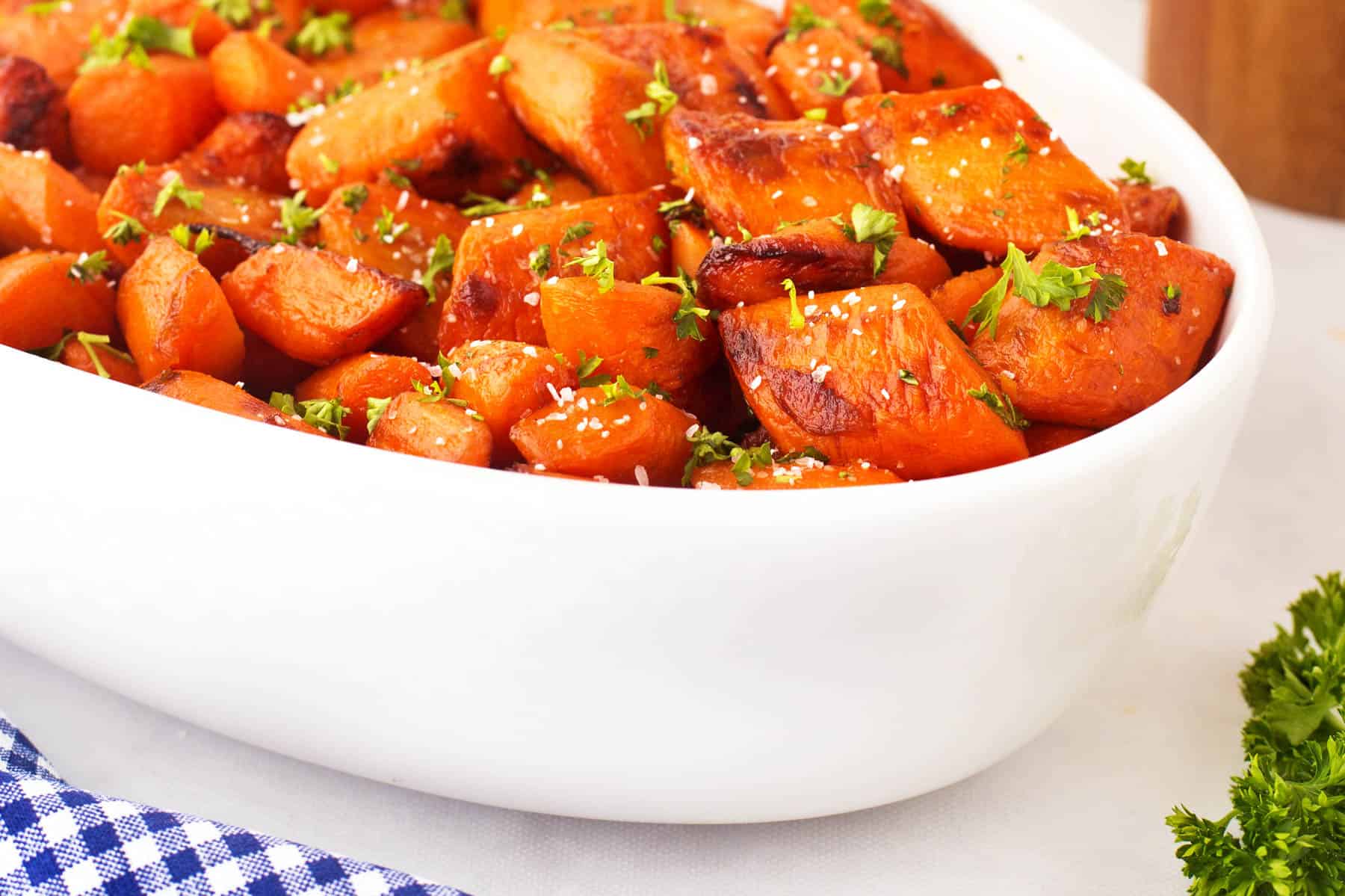 Caramelized carrots in a large white bowl. 