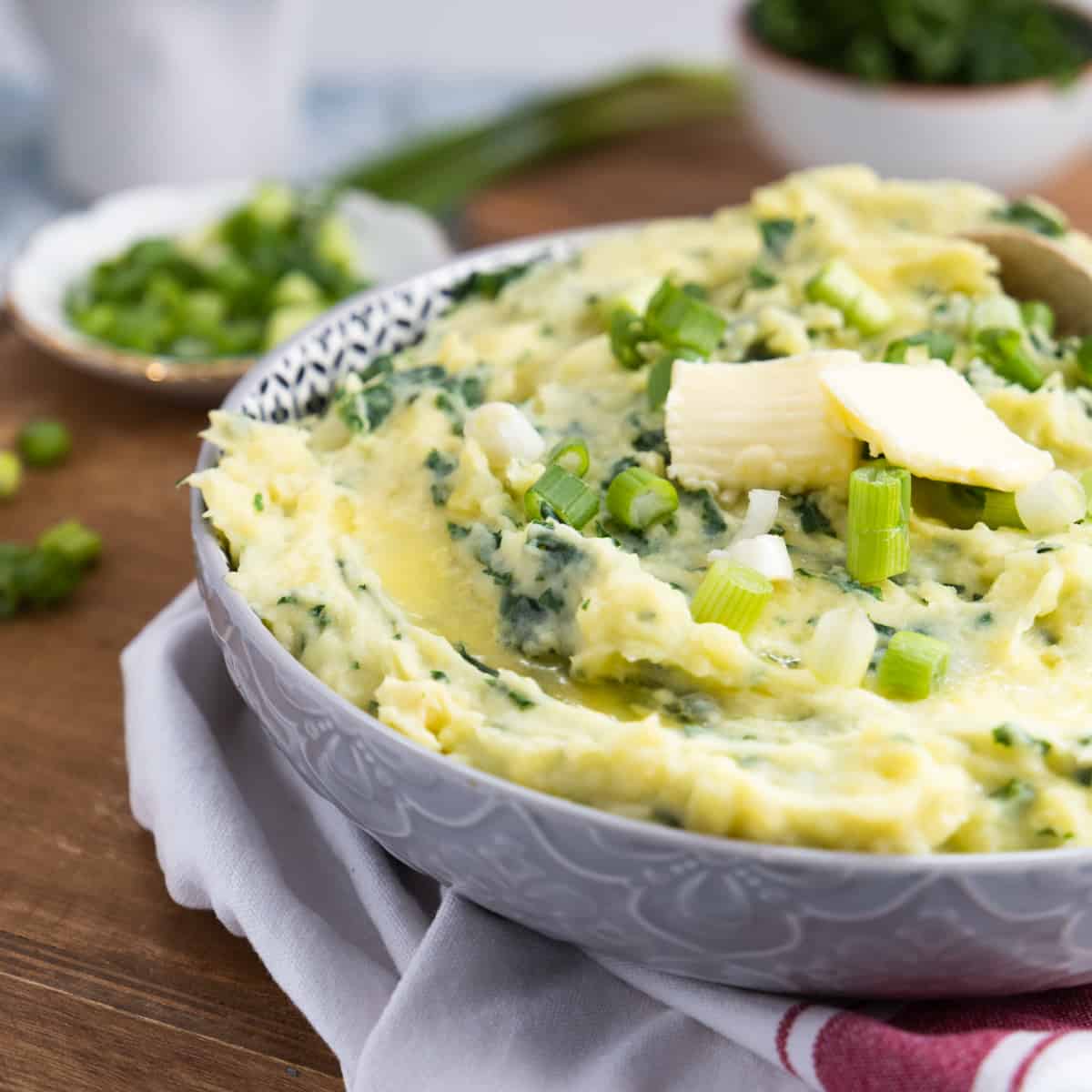 Colcannon in a bowl with two pats of butter
