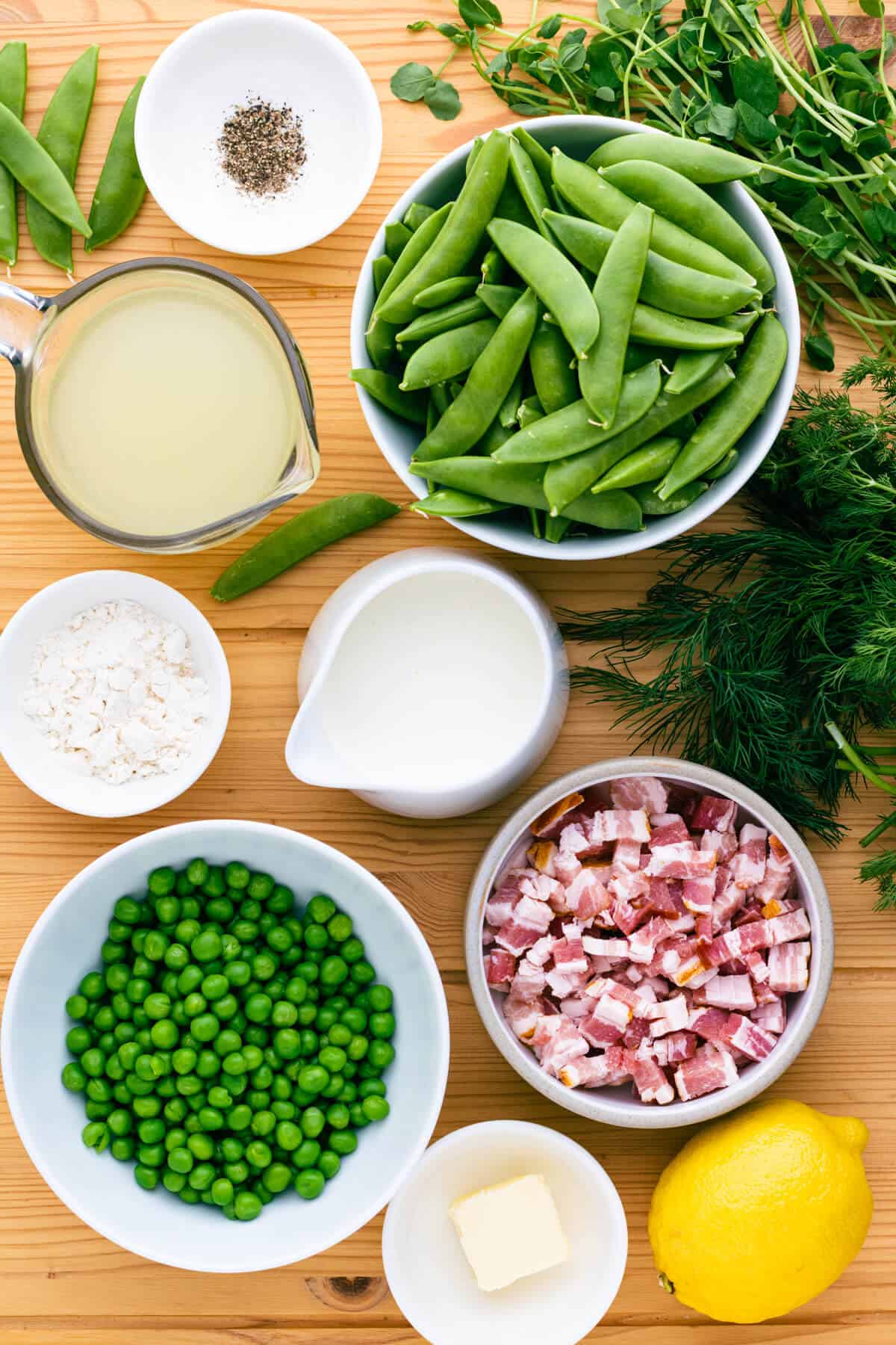 Ingredients for creamy sugar snap peas with bacon side dish.