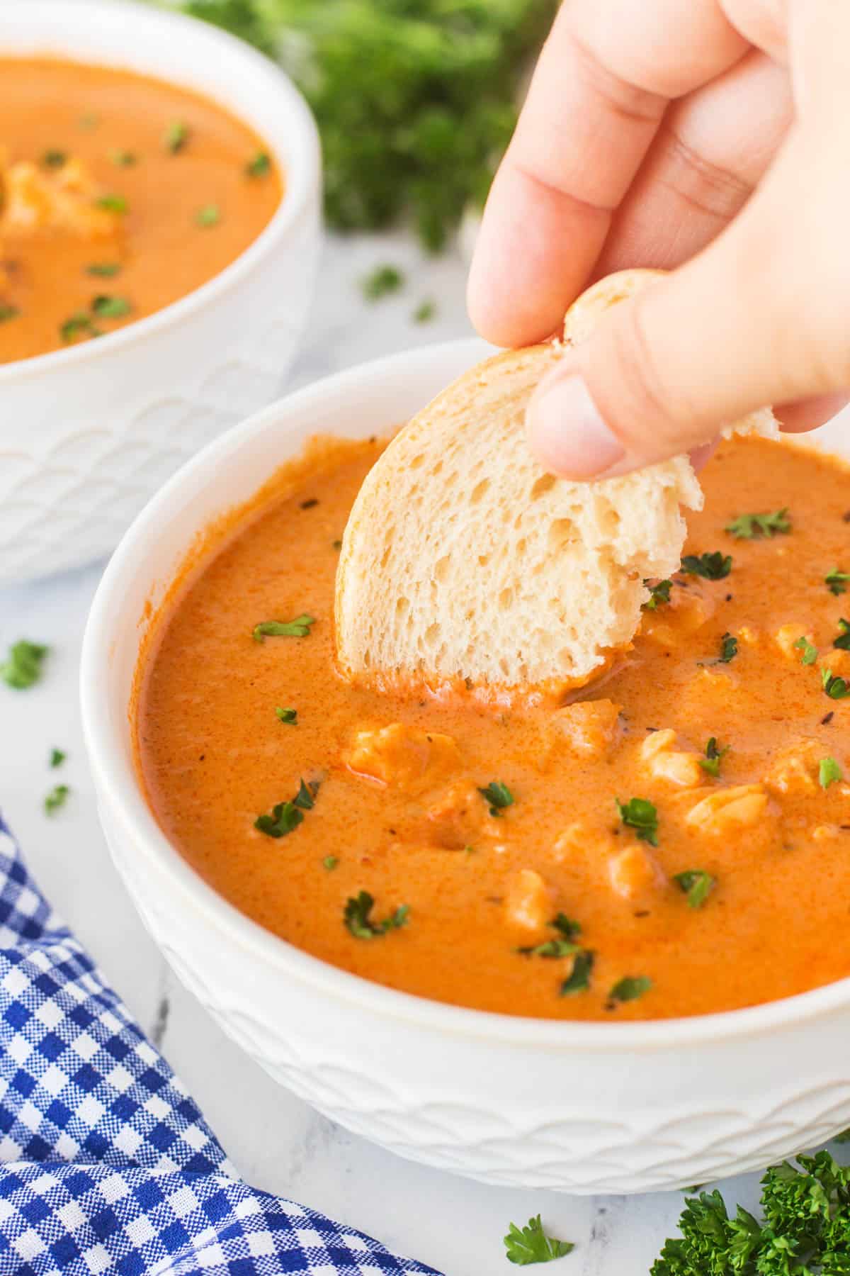 Dunking in a slice of bread into a bowlful of lobster bisque. 